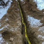 Caution tape over pipe