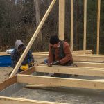 Chris nailing studs into wall 4