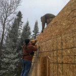 Sheathing the gable ends, Terry is prepping for the ladders